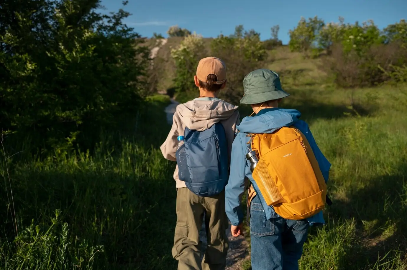Rear view of kids exploring a natural environment.